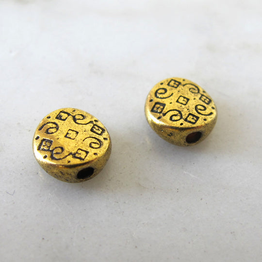 Muntje oud goud met motiefje