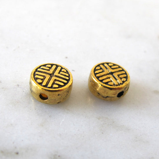 Muntje oud goud met motiefje