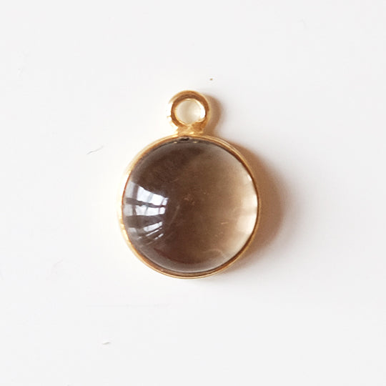 Bedel cabochon rookkwarts, verguld